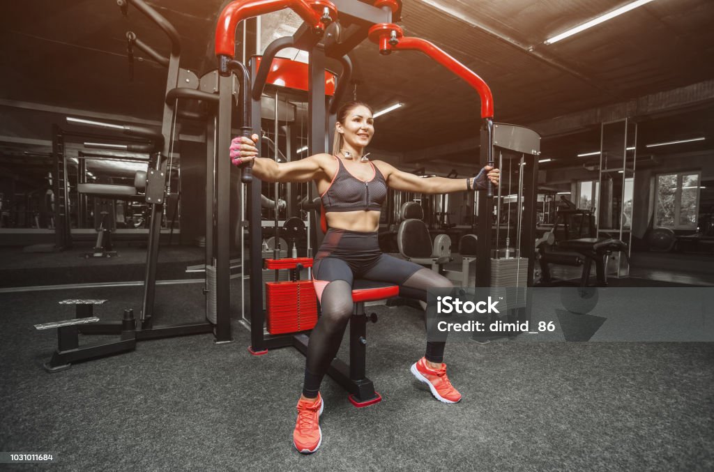 Slim Bodybuilder Girl Does The Exercises For Arms In The Gym Stock Photo -  Download Image Now - iStock