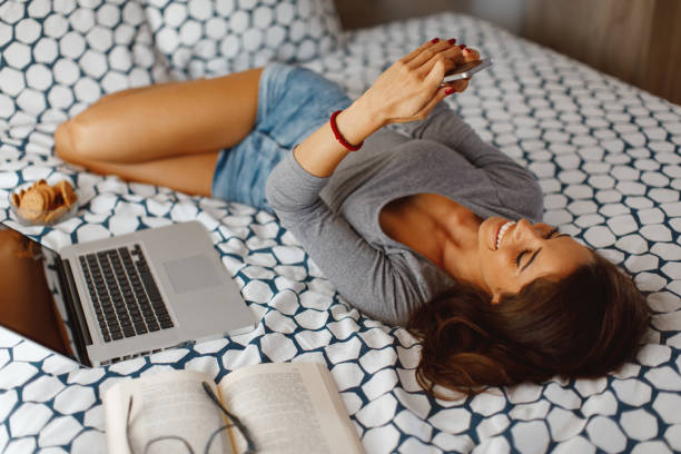 istock Young woman texting from the bed 1031014380
