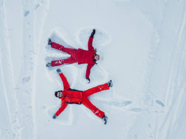 istock Drone view of couple making snow angel 1031015106