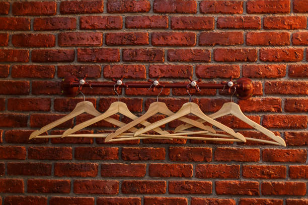 istock empty hangers on a background of red bricks 1031026098