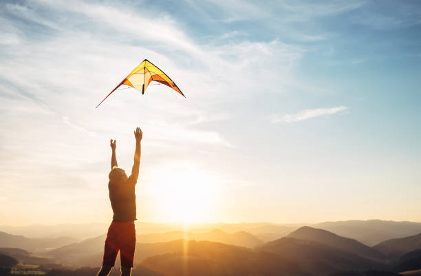 Man start to fly a kite in the sky stock photo