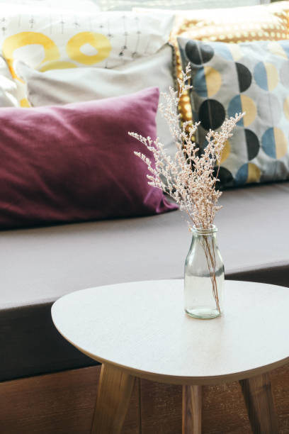 istock Flower Vase On Table Against Sofa 1031034380