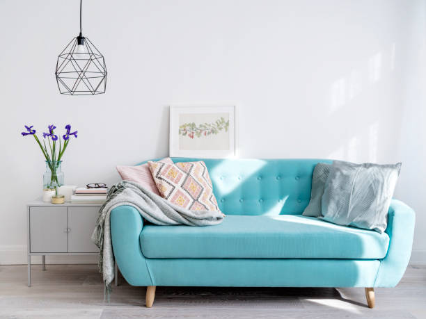 istock Bright blue sofa in stylish home interior 1031037432