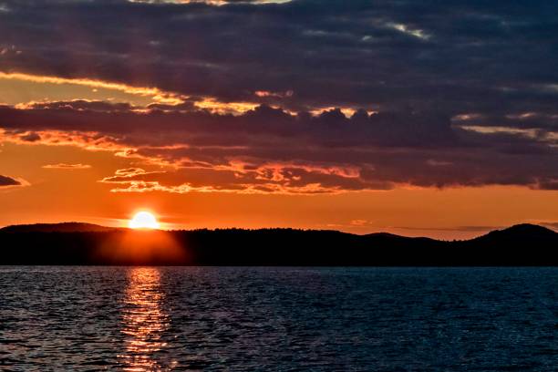 istock Golden sun sinks over the lake in the evening 1031042914
