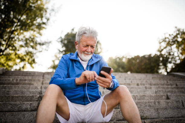 istock Sporty senior man using mobile phone. 1031050034