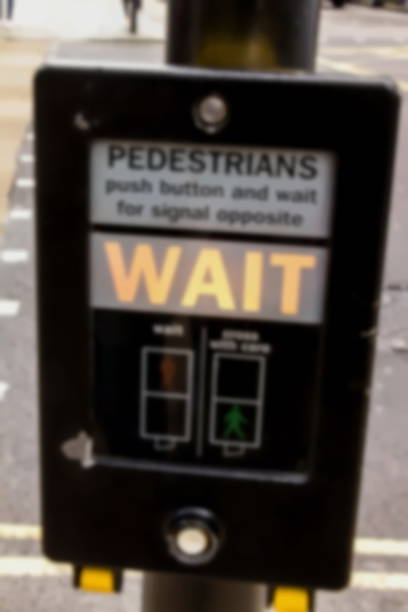 istock Blurred view of crosswalk button for pedestrian with light warning. London. 1031058800