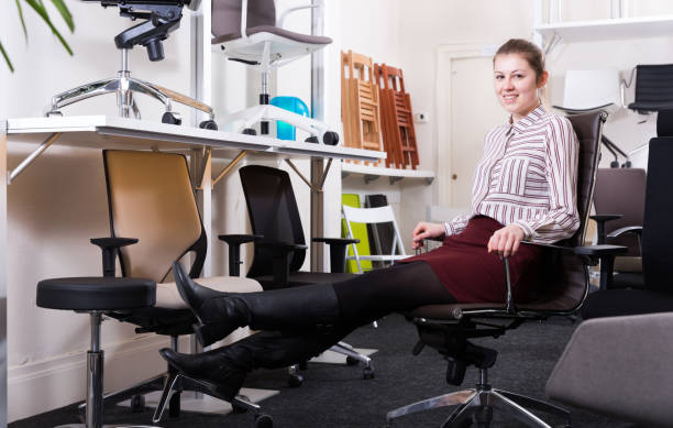 istock Young woman testing new chairs in salon 1031059646