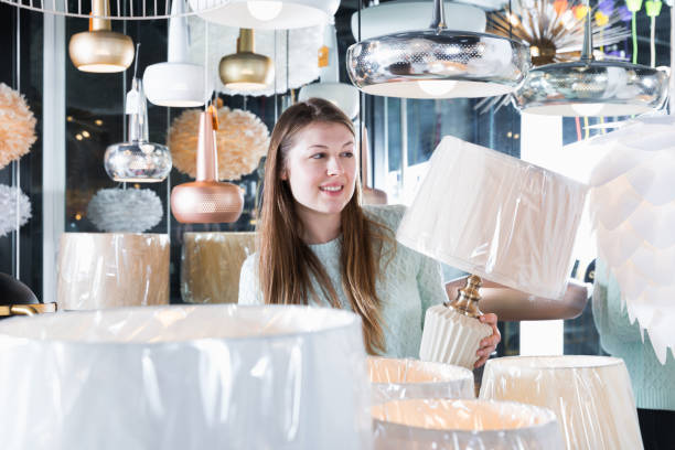 istock Young woman buyer choosing modern torchere 1031060430