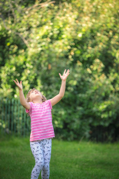 istock Girl waiting to catch a falling ball 1031066558