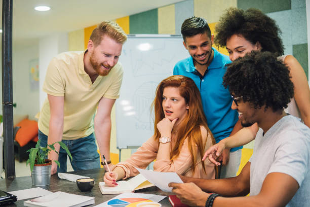 istock Young woman with work colleagues at office 1031067372