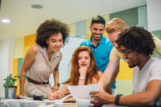 istock Small group of people revising paperwork at work 1031067374