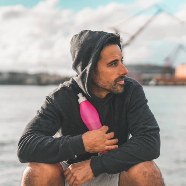 istock Man resting in the harbor after outdoor exercise 1031069836