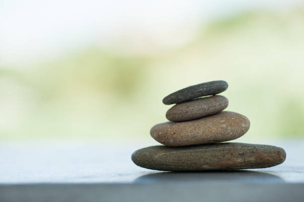 istock Group of stones on white background with sunlight. 1031071024