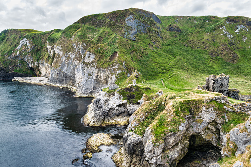 Thi is Kinbane Castle which was built on a small peninsula of sea cliffs that protrude into the Atlantic Ocean close to the town of Ballycastle in Northern Ireland. just below the Castle a sea cave.