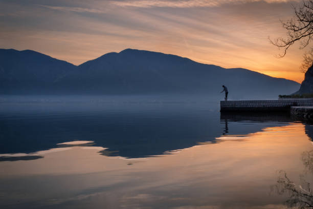 istock Lonely Sunset Fisherman 1031087944