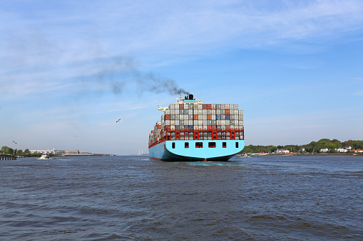 containership leaving the port of hamburg