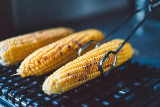 Grilling the corn on a barbecue grill, summer grilling, corn on the cob, food is life, summer picnic food is the best.