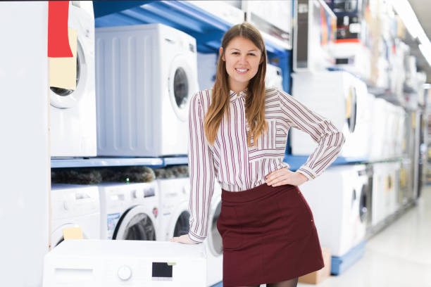istock smiling saleswoman offering clothes washer 1031091052