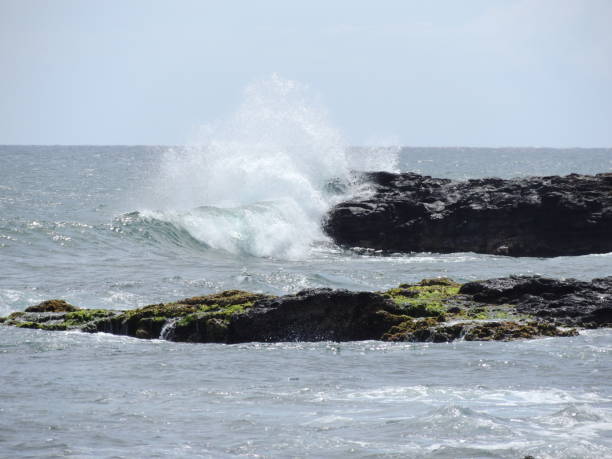 istock Waves crashing on the rocks 1031091226