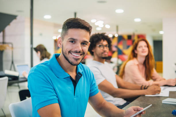 istock Smiling young man holding a sheet of paper at work 1031091732
