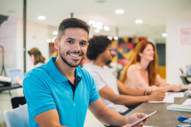 istock Smiling young man at the meeting at work 1031091762
