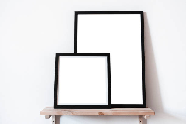 istock Posters square portrait format in black frame in white stylish modern interior on shelf, living room. Design template mockup. 1031094166