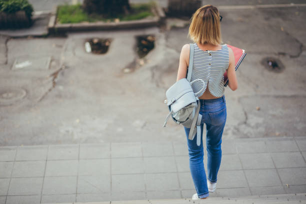 istock Woman student going down the stairs 1031106468