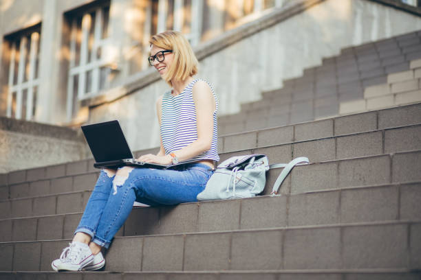 istock Student girl studying with laptop on a staircase 1031108976
