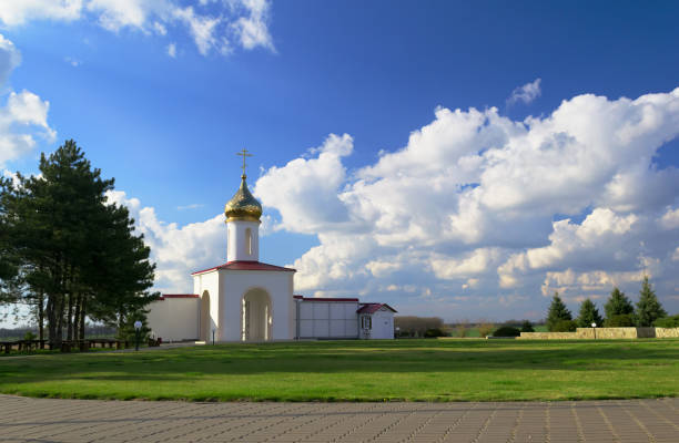 church building against a beautiful blue sky with clouds