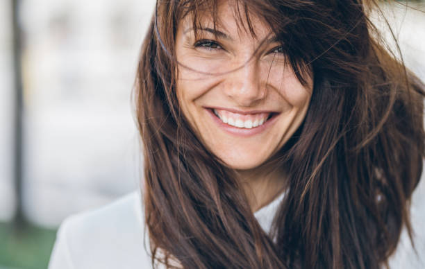 istock Smiling woman on a windy day 1031134652