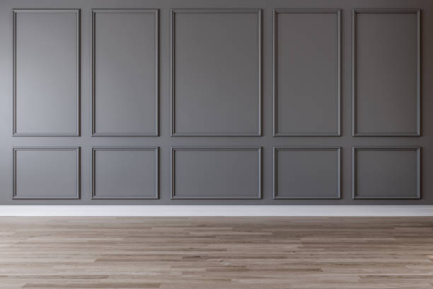 istock Empty room with dark gray wall, moldings and wooden floor 1031137056