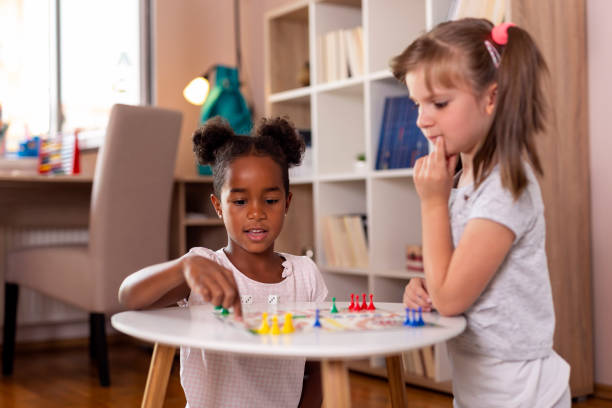 istock Girls playing ludo board game 1031144350