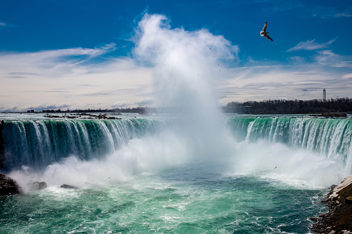 Niagara Falls, Canada - August 14, 2022: People having fun on a tourboat at the Niagara Falls in Canada