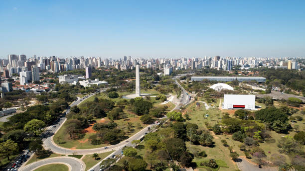 Aerial view of Ibirapuera park in Sao Paulo city, obelisk monument, Brazil. Aerial view of Ibirapuera park in Sao Paulo city, obelisk monument. Prevervetion area with trees and green area of Ibirapuera park. Office buildings and apartments in the background on a sunny day. ibirapuera park stock pictures, royalty-free photos & images