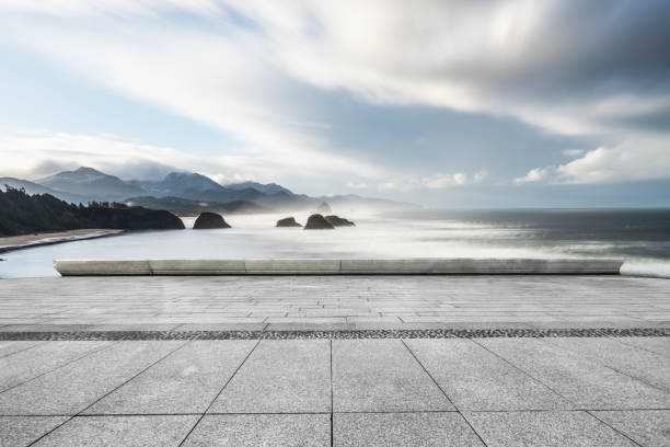istock empty parking lot by sea against sky 1031164400