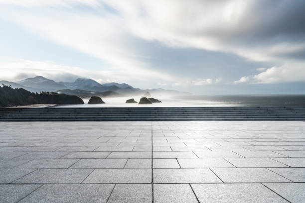 istock empty parking lot by sea against sky 1031164412