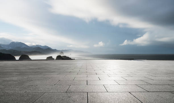 istock empty parking lot by sea against sky 1031164422
