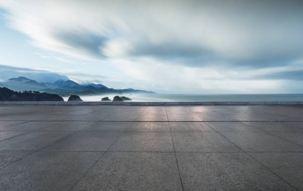 istock empty parking lot by sea against sky 1031164900