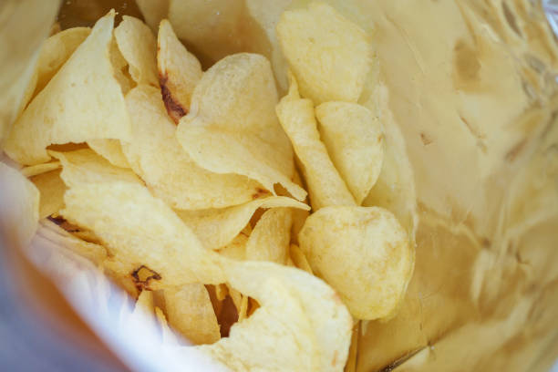 istock Potato chips in open snack bag close up 1031169762