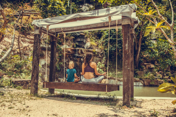 istock Woman and boy practicing yoga 1031169882