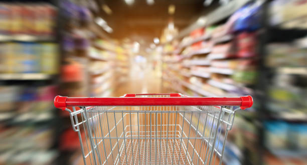istock supermarket aisle blur abstract background with empty red shopping cart 1031169948