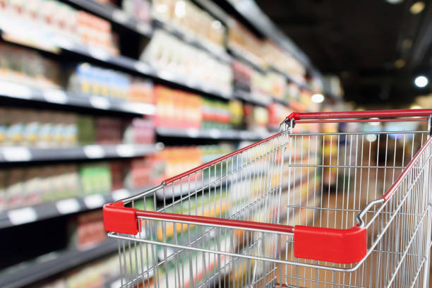 istock supermarket aisle blurred background with empty red shopping cart 1031169950