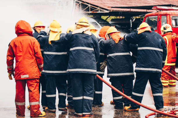 istock Firefighters training , Firefighter spraying high pressure water to fire 1031177576
