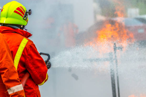 istock Firefighters training , Firefighter spraying high pressure water to fire 1031177662