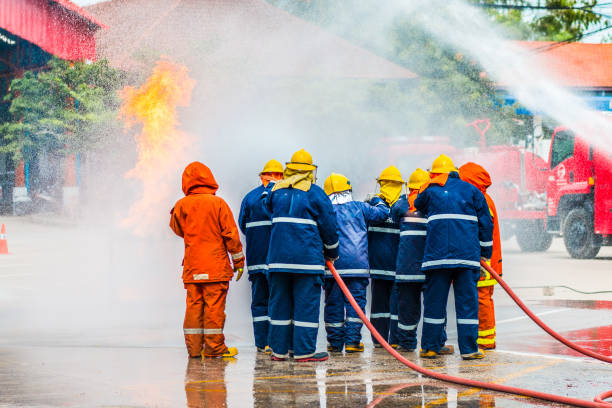istock Firefighters training , Firefighter spraying high pressure water to fire 1031177704