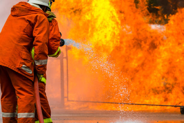 istock Firefighters training , Firefighter spraying high pressure water to fire 1031177722