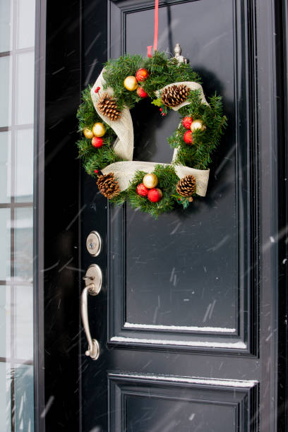 istock Christmas wreath on black door. 1031210750