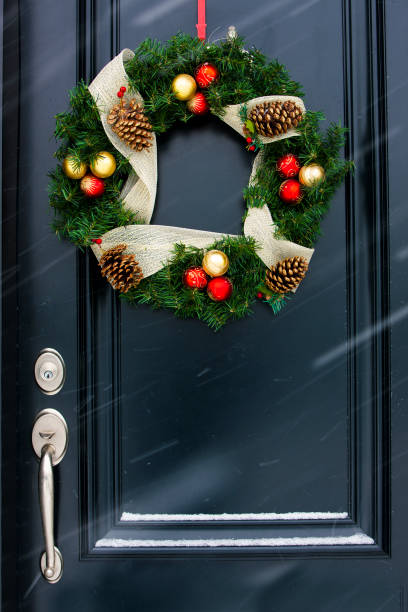 istock Christmas wreath on black door. 1031210932