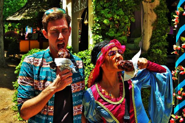 Friends eating turkey legs.