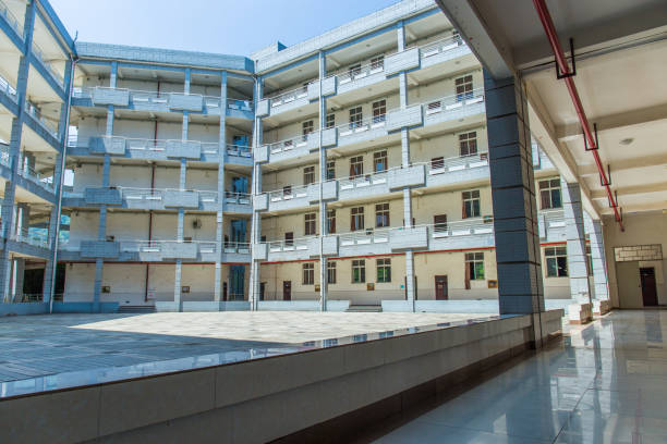 istock Modern school building on the university campus, surrounded by floors, with a square in the middle, sunny in summer 1031223988